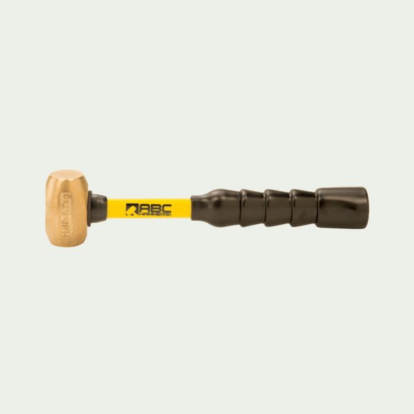 A Brass Hammer With Black Fiber Glass Handle