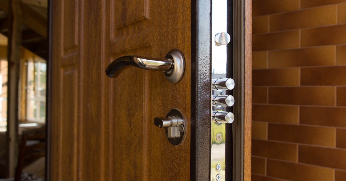 A heavy-duty steel bolt door lock system with multiple locking points on a wooden door frame for enhanced security.