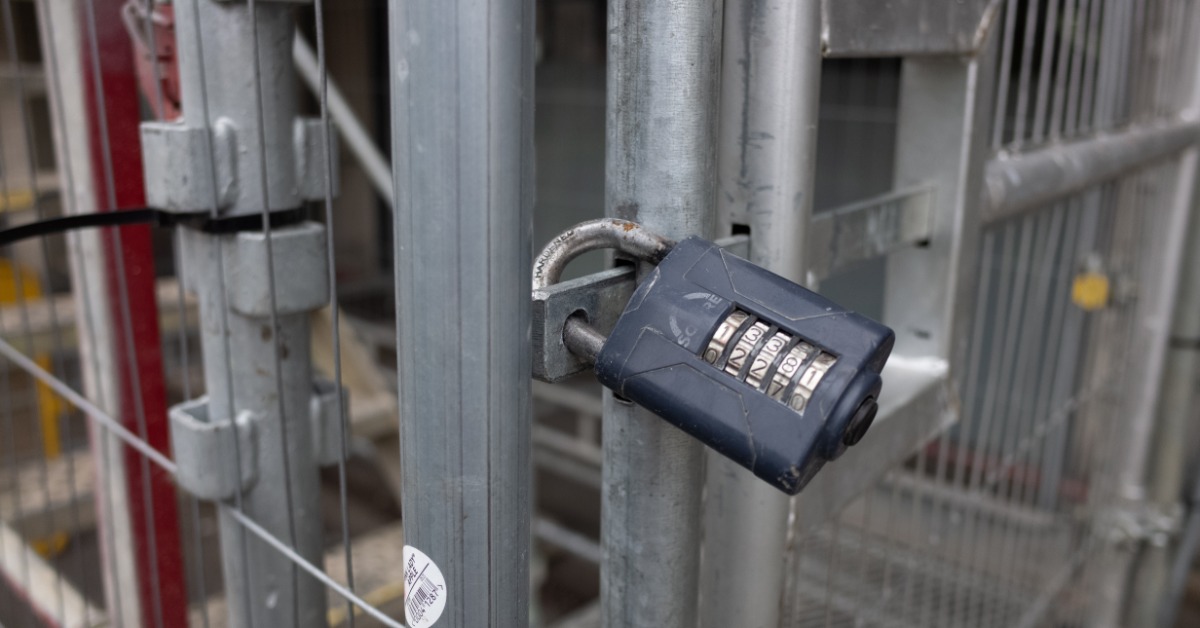Red lockout tagout padlocks secured to industrial electrical panel switches with Danger Locked Out Do Not Remove safety labels.
