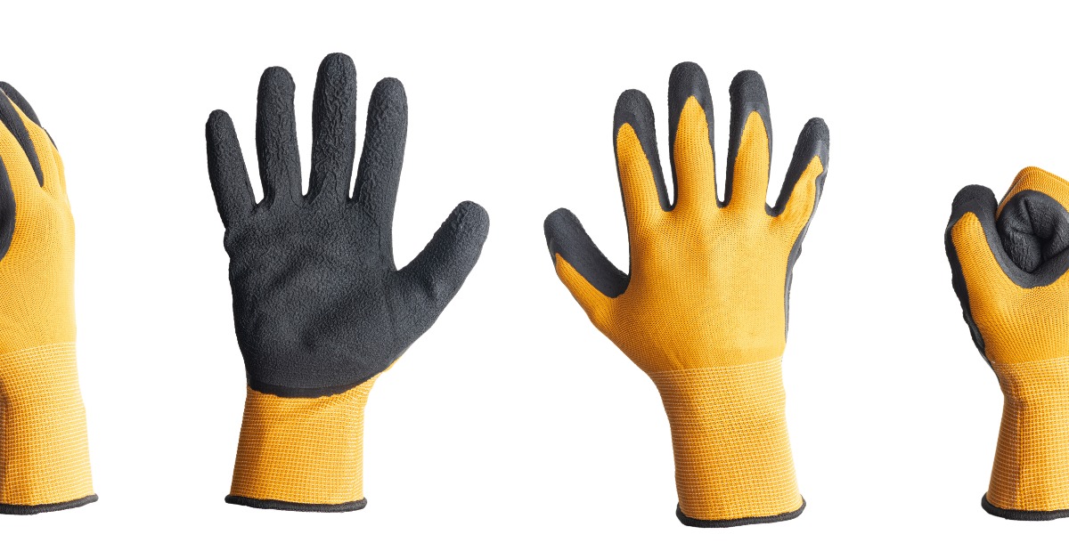 A series of four rubber work gloves in a line. The last glove is balled up in a fist while the others are open.